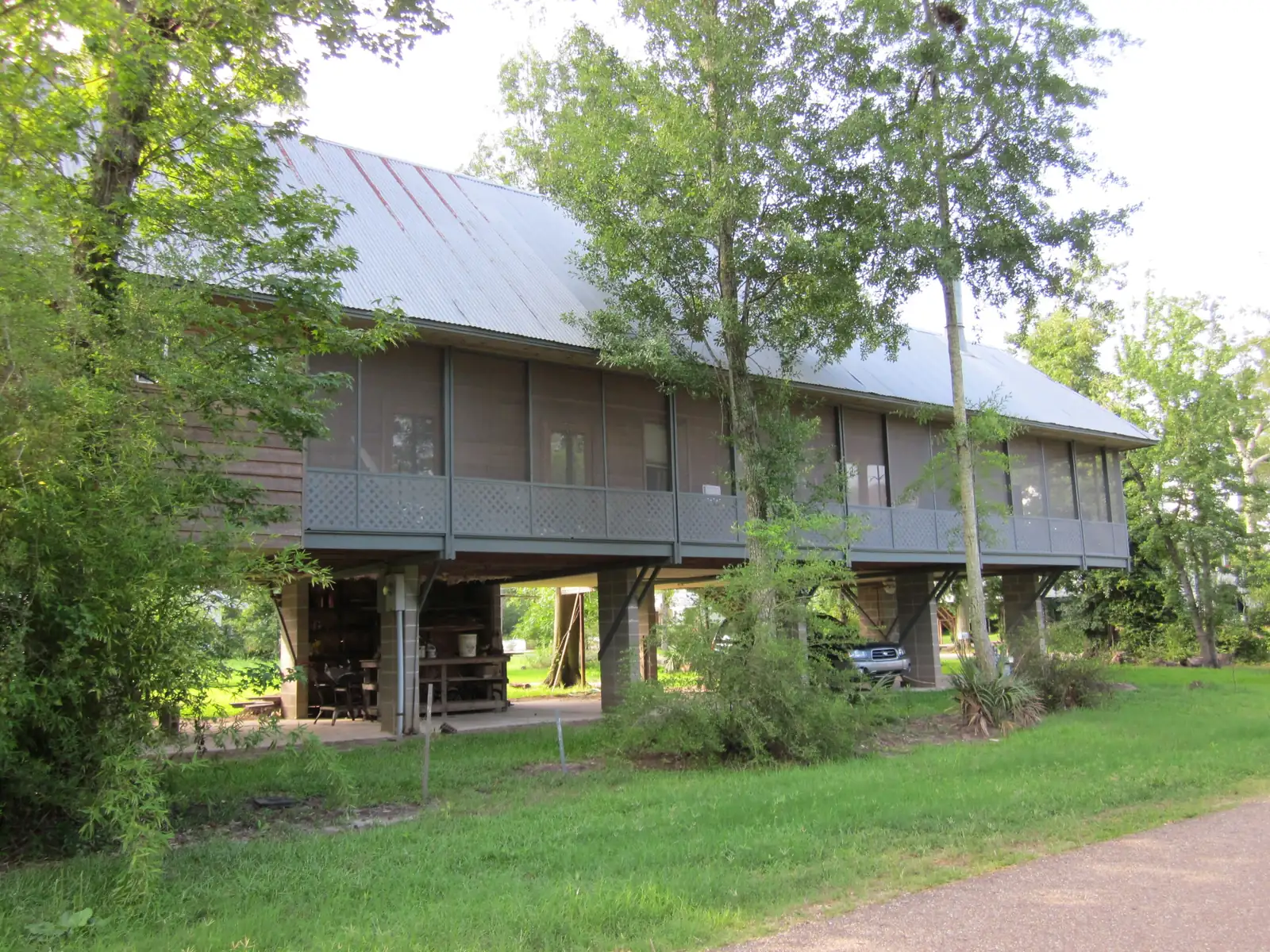A long house raised on piers with parking underneath in Mandeville, Louisiana