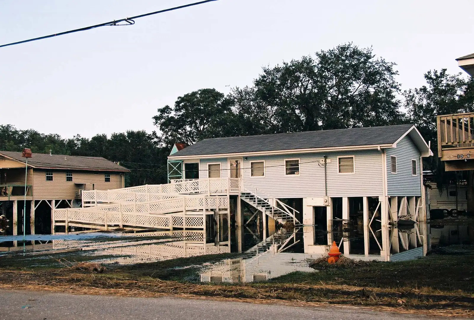 Raised houses on pilings above flood water in Pointe-aux-Chenes after Hurricane Lili, 2002